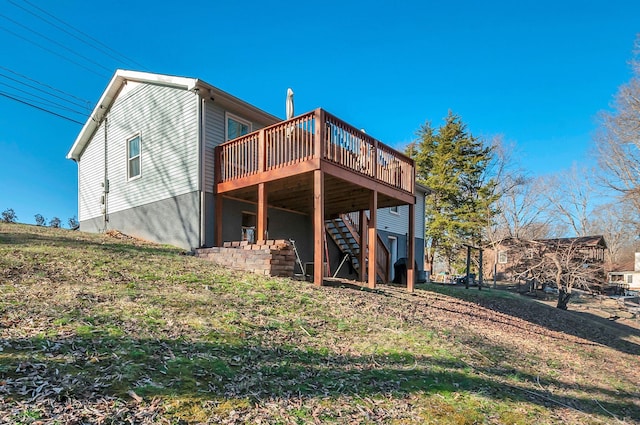 back of property featuring stairway and a wooden deck