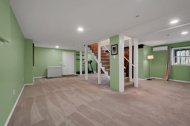 below grade area featuring recessed lighting, a wall unit AC, stairway, and baseboards