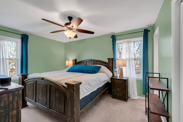 bedroom with ceiling fan and light colored carpet