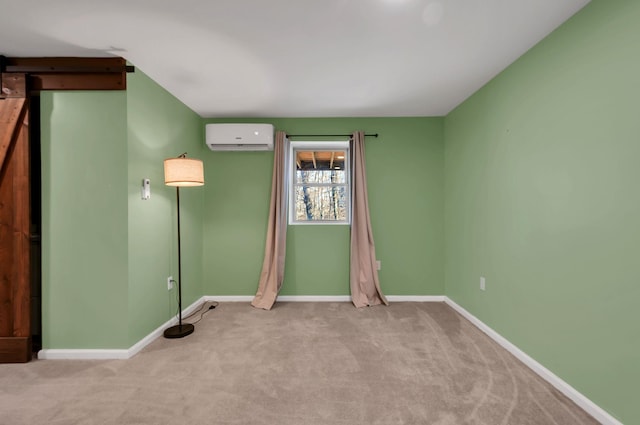 unfurnished room featuring carpet floors, a barn door, baseboards, and an AC wall unit