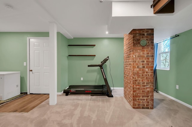 workout room with baseboards and carpet flooring