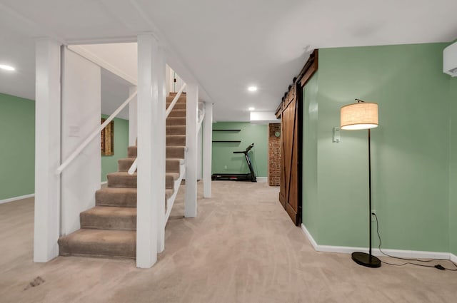 interior space with a barn door, carpet, recessed lighting, and baseboards