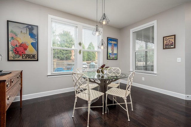 dining space featuring a healthy amount of sunlight, baseboards, and dark wood-style flooring