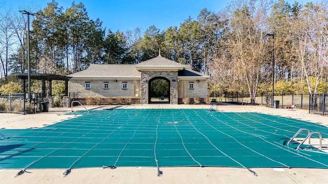 view of swimming pool featuring a patio, fence, and a fenced in pool