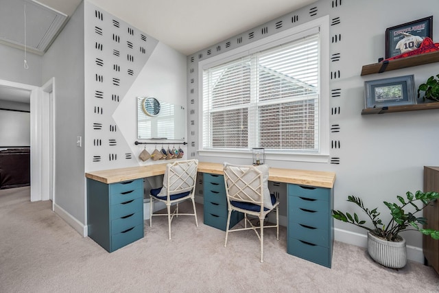 home office with attic access, baseboards, and light colored carpet