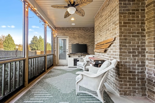 unfurnished sunroom with a ceiling fan