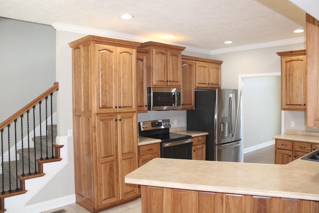 kitchen featuring recessed lighting, appliances with stainless steel finishes, crown molding, and light countertops
