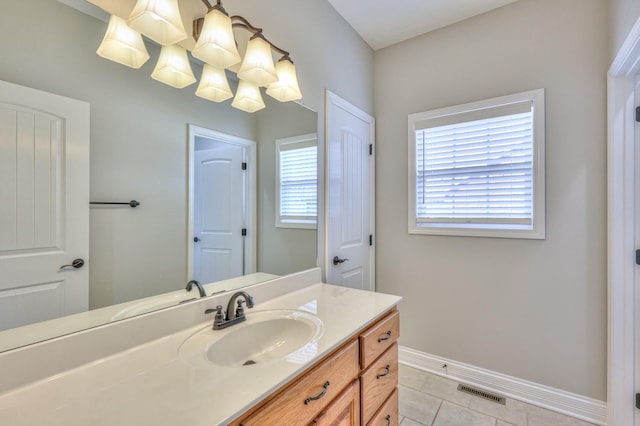 bathroom featuring tile patterned flooring, vanity, baseboards, and visible vents