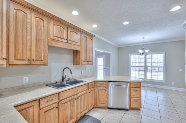 kitchen featuring a sink, a peninsula, light countertops, and stainless steel dishwasher