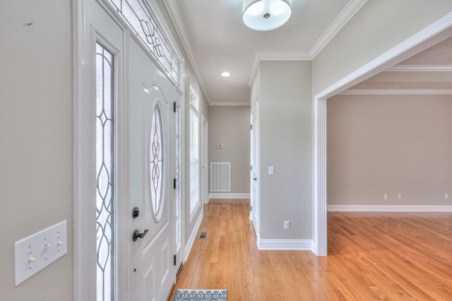 foyer featuring visible vents, crown molding, baseboards, light wood-type flooring, and recessed lighting