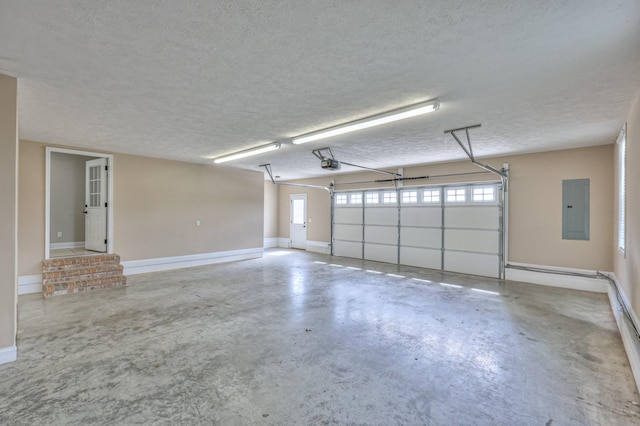 garage with electric panel, a garage door opener, and baseboards