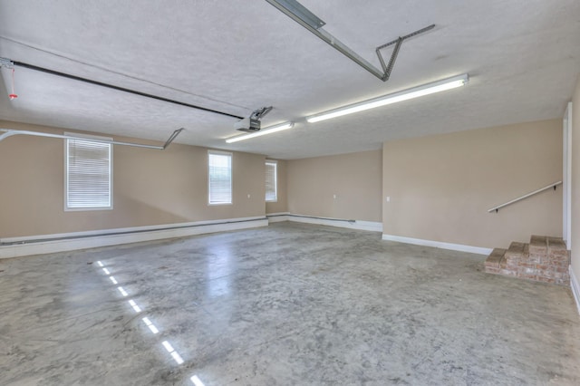 garage with a garage door opener and baseboard heating