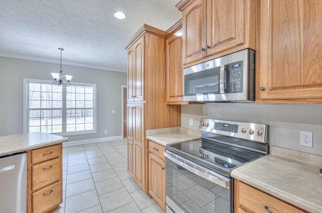 kitchen featuring crown molding, a chandelier, light countertops, stainless steel appliances, and a textured ceiling