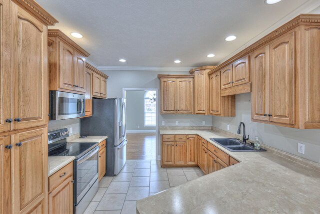kitchen featuring light countertops, ornamental molding, light tile patterned floors, stainless steel appliances, and a sink