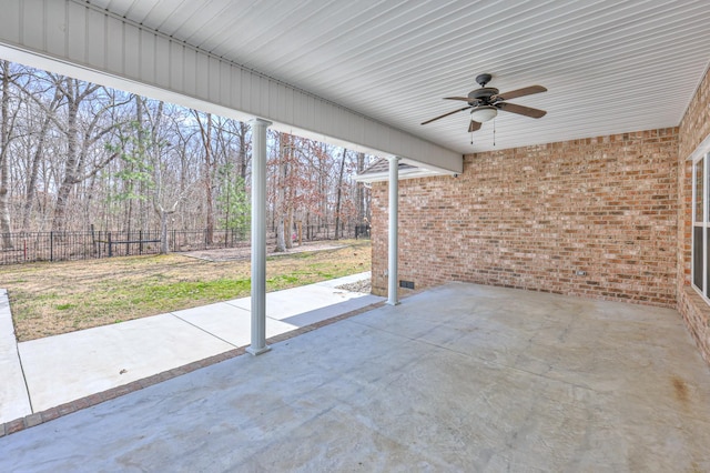 view of patio / terrace with ceiling fan and fence