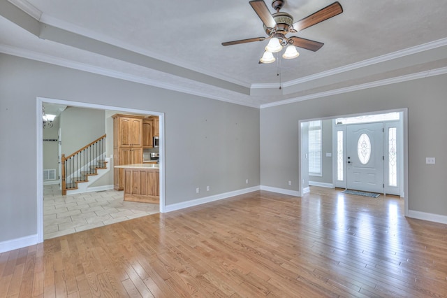 interior space with light wood finished floors, visible vents, baseboards, stairs, and ceiling fan with notable chandelier
