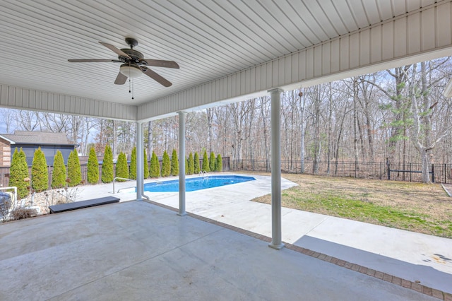 exterior space featuring a fenced in pool, a patio, a fenced backyard, and a ceiling fan