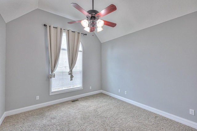unfurnished room featuring visible vents, baseboards, vaulted ceiling, carpet flooring, and a ceiling fan