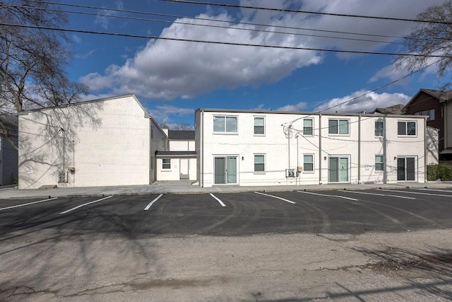 view of building exterior featuring uncovered parking