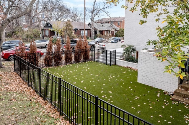 view of yard featuring a residential view and fence