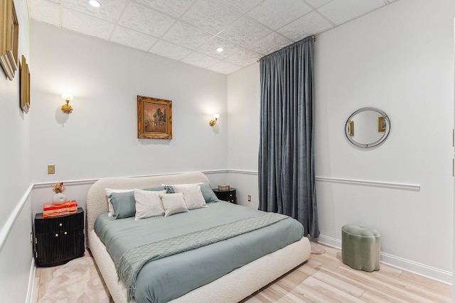 bedroom with recessed lighting, baseboards, and wood finished floors