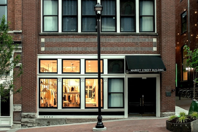 entrance to property featuring brick siding