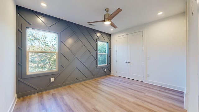 spare room featuring light wood-style flooring, visible vents, baseboards, and recessed lighting