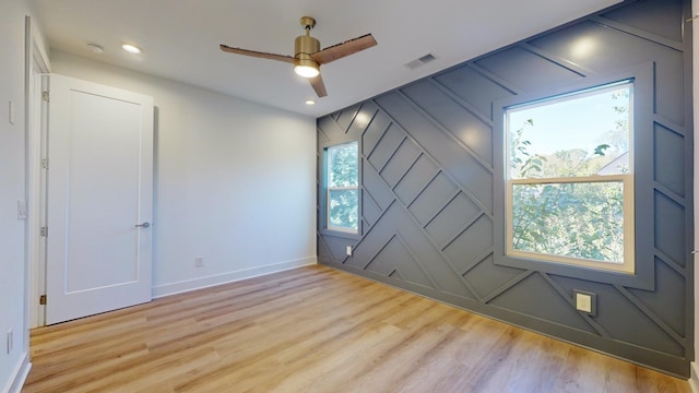 unfurnished room with recessed lighting, visible vents, baseboards, and wood finished floors