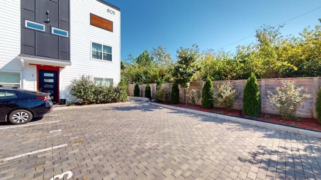 exterior space with uncovered parking and fence