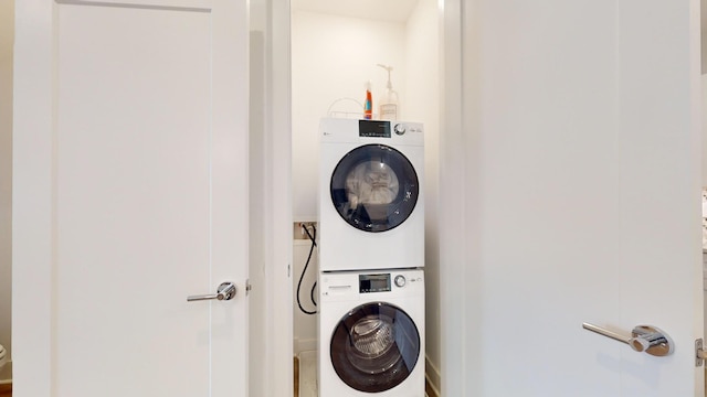 laundry area with laundry area and stacked washer / dryer