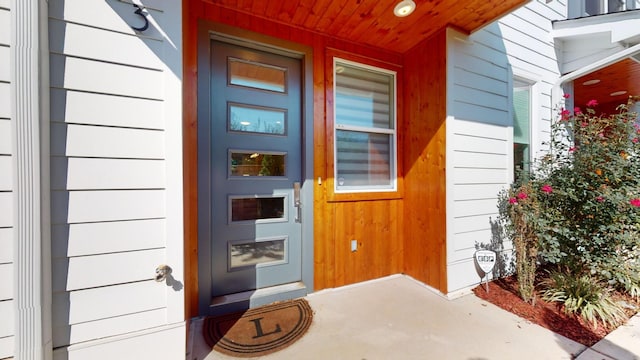 view of exterior entry with covered porch