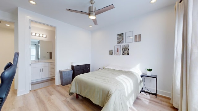 bedroom featuring light wood-type flooring, a sink, and recessed lighting