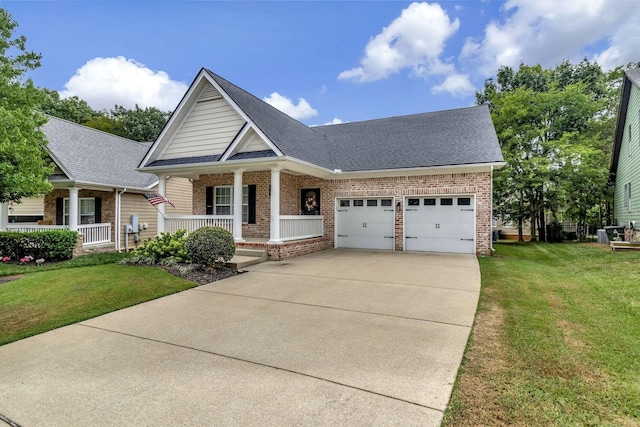 view of front facade with a porch, a garage, brick siding, concrete driveway, and a front yard