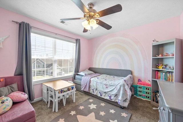 carpeted bedroom with baseboards, ceiling fan, visible vents, and a textured ceiling