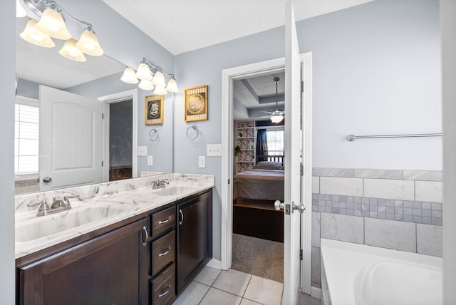 full bathroom with a garden tub, a sink, ensuite bath, and double vanity