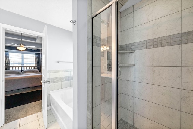 full bathroom featuring a ceiling fan, a bath, tile patterned floors, a stall shower, and ensuite bath