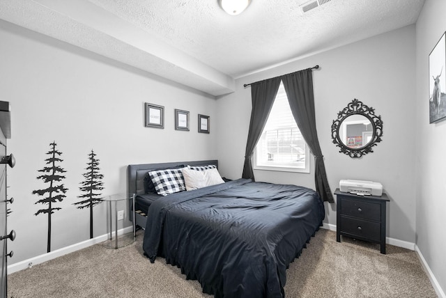 carpeted bedroom featuring baseboards, visible vents, and a textured ceiling