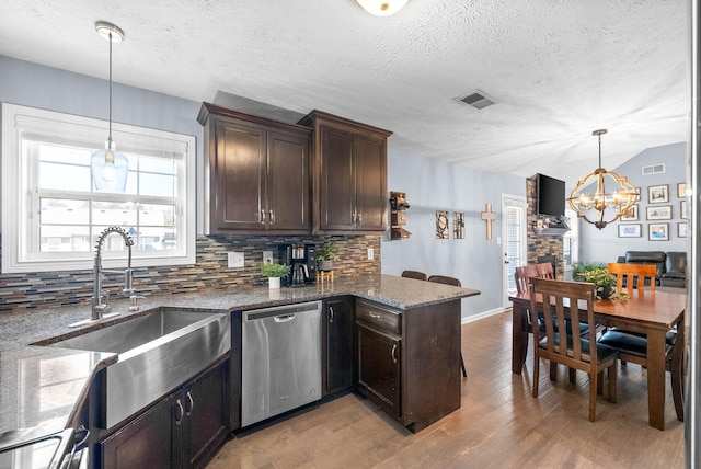 kitchen featuring a sink, dark brown cabinetry, decorative backsplash, and stainless steel dishwasher