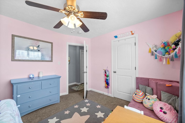 bedroom featuring ceiling fan, dark colored carpet, and baseboards