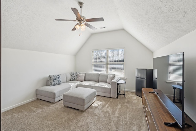 carpeted living room featuring vaulted ceiling, a textured ceiling, and baseboards