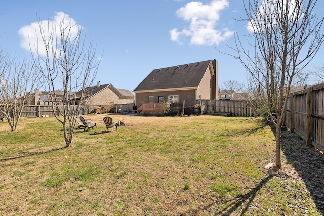 view of yard featuring a fenced backyard and a deck