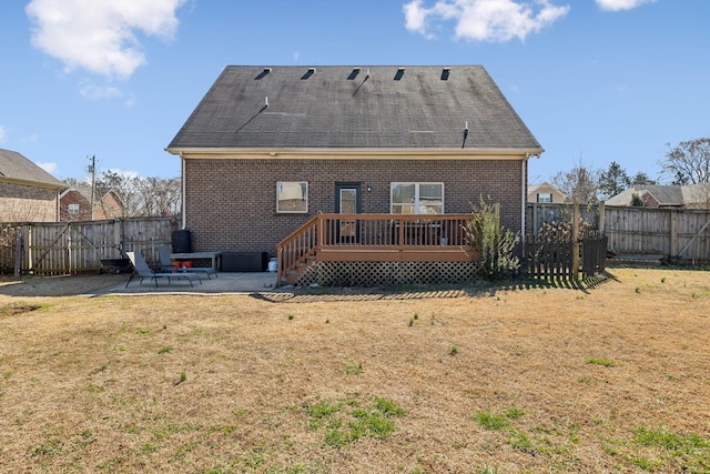 rear view of property with a yard, a fenced backyard, a patio, and a deck