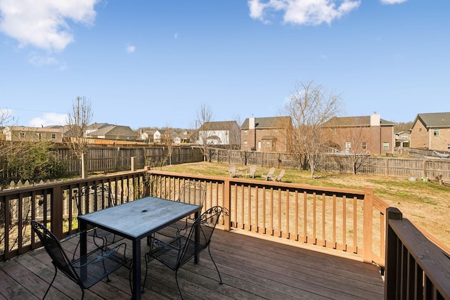 deck with a fenced backyard, a residential view, and outdoor dining space