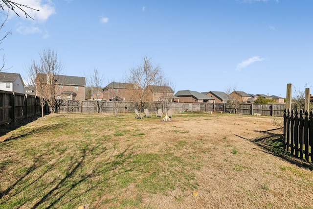 view of yard with a fenced backyard and a residential view