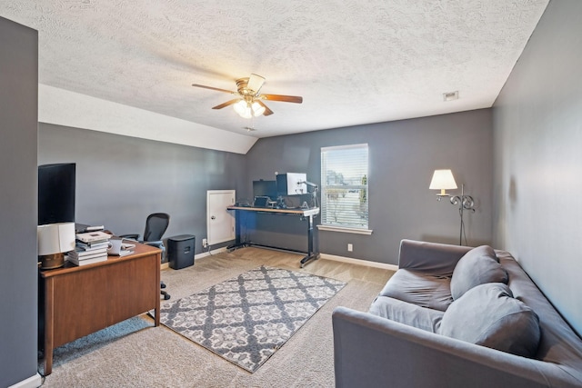 carpeted office with lofted ceiling, visible vents, ceiling fan, a textured ceiling, and baseboards