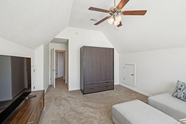 sitting room featuring baseboards, visible vents, vaulted ceiling, a textured ceiling, and carpet floors