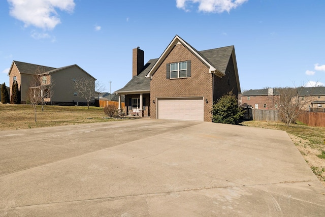 traditional-style home featuring an attached garage, brick siding, fence, driveway, and a chimney