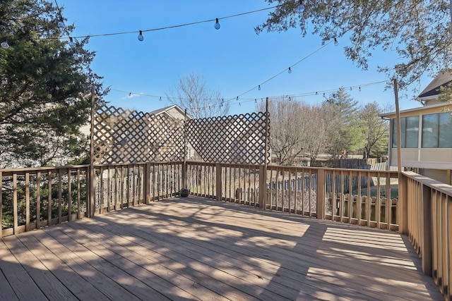 wooden terrace featuring fence