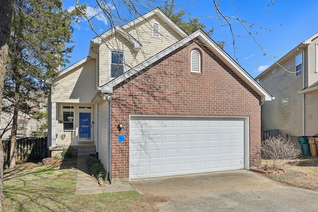 traditional home featuring an attached garage, concrete driveway, and brick siding