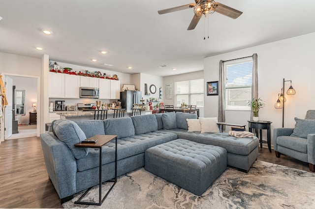 living area featuring a ceiling fan, recessed lighting, and wood finished floors